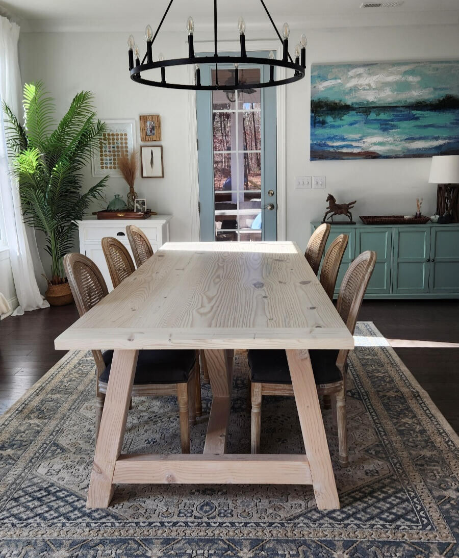 Custom dining table with cane-back chairs in natural light