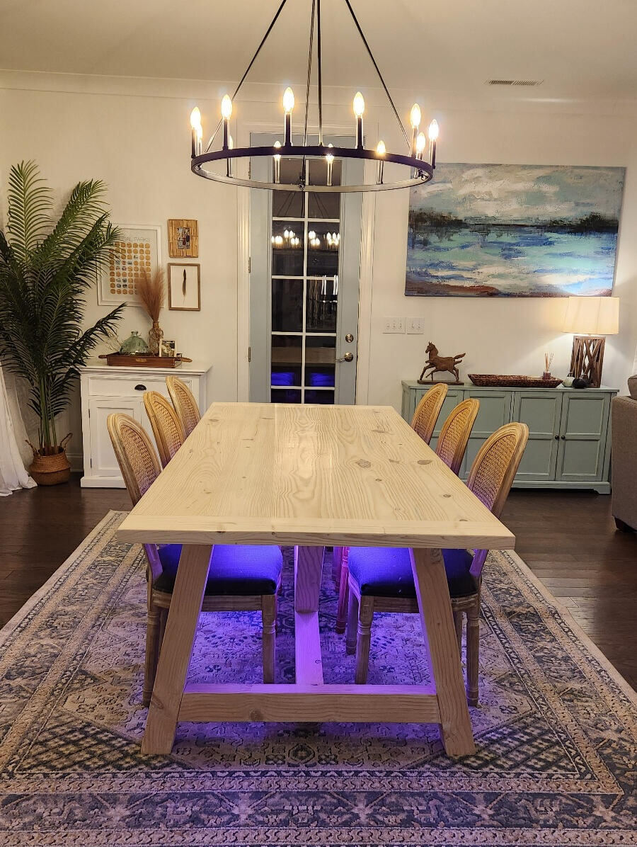 Dining table with integrated LED underlighting at night