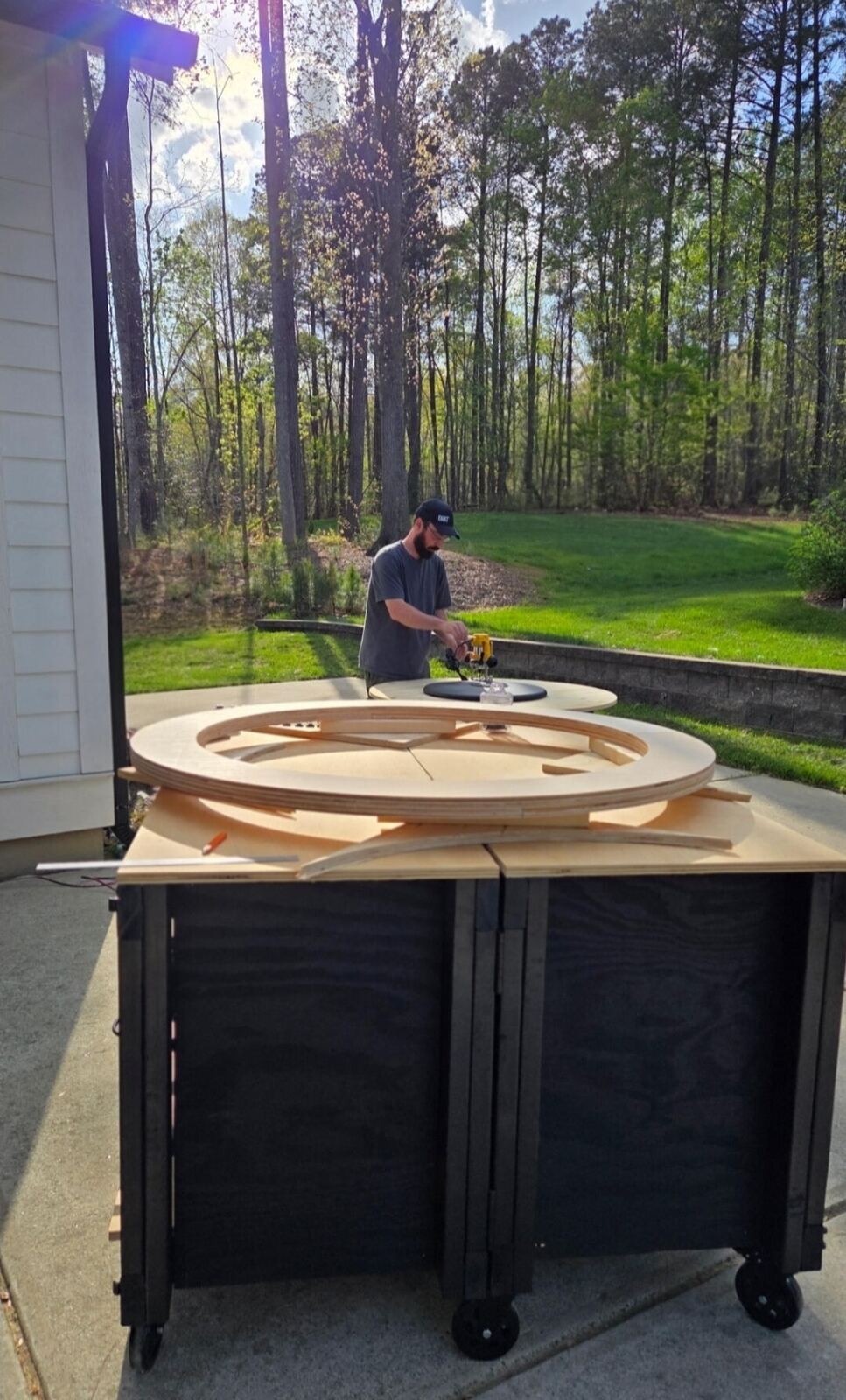 Mike routing a curved tabletop outside his shop