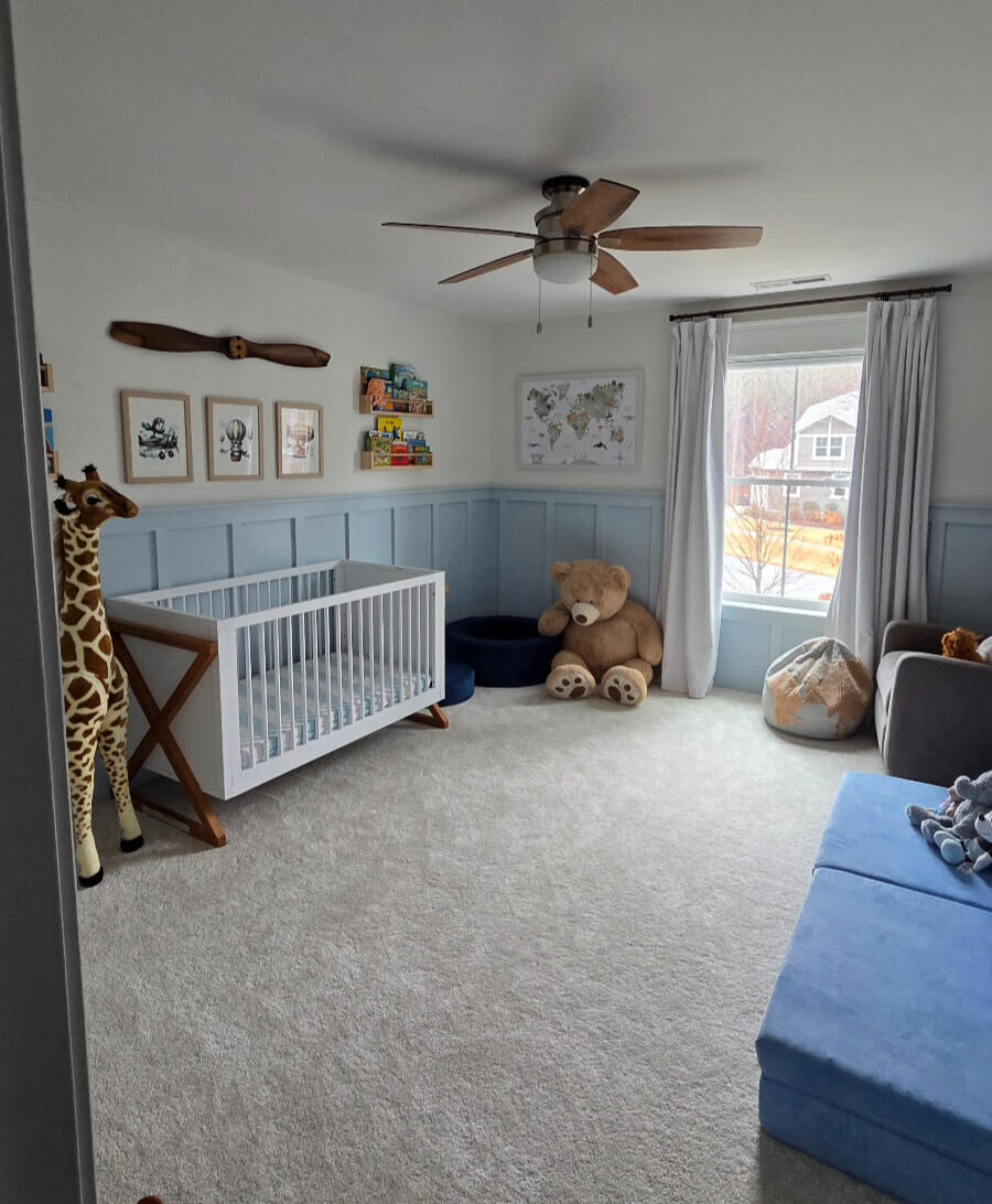 Nursery room with built-in board and batten trim